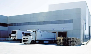 Lorries unload goods in the warehouse as part of cross-docking operations