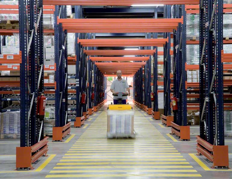 Operator handling a load using a pallet truck. 