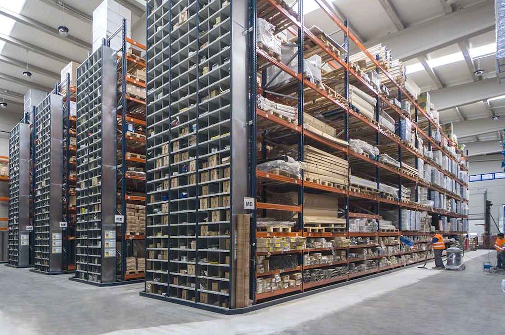 Operators perform cleaning tasks in a warehouse with pallet racking