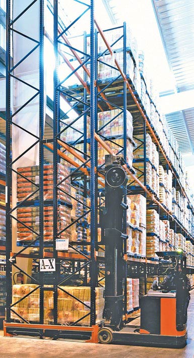 Image of a double-reach truck used in a warehouse for mass-market food products. 