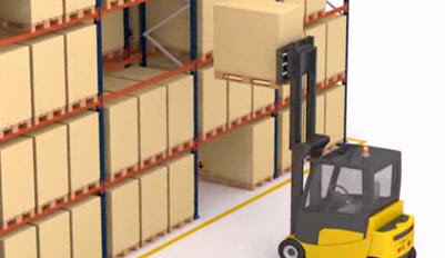 Forklift loads palletised goods from buffer on triple-width pallet racks.