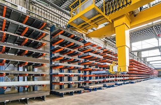 Employing automatic overhead cranes speeds up loading and unloading in warehouses with cantilever racking