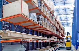 Securing a continuous run of wooden shelving to cantilever arms allows for the storage of palletised loads