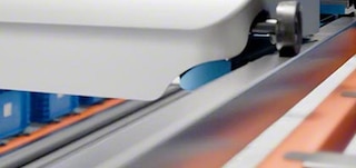 Shuttles travel along the rails at each storage level