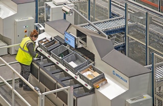 The operator receives the bins at the pick station and retrieves the required items