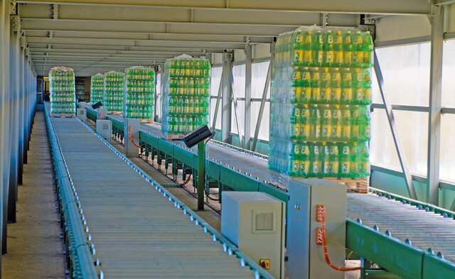 The warehouse is connected with the production area via a 100 m long overpass fitted with roller conveyors