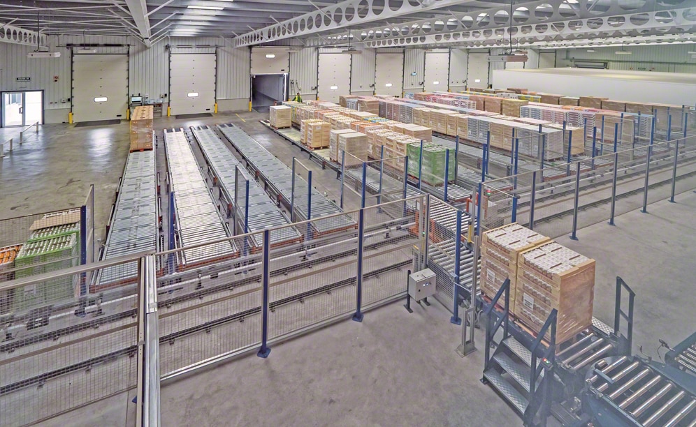 Two shuttles are tasked with depositing the pallets in one of the pallet flow channels available on the ground level