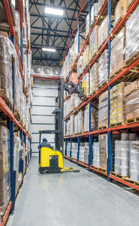 In this warehouse, the reach trucks used incorporate a scissor or pantograph system in the fork carriage